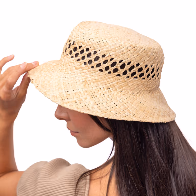 Model wearing a woven straw bucket hat